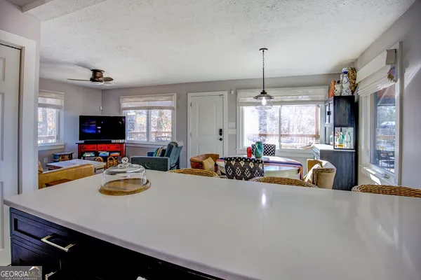 a bathroom with a granite countertop sink a large mirror and a window