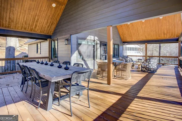 a dining room with furniture a rug and wooden floor