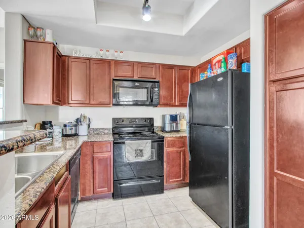 a kitchen with stainless steel appliances granite countertop a stove sink and cabinets