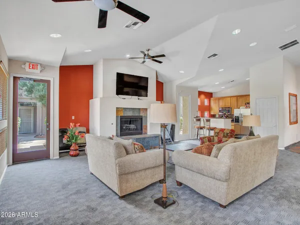 a living room with furniture a fireplace and a flat screen tv