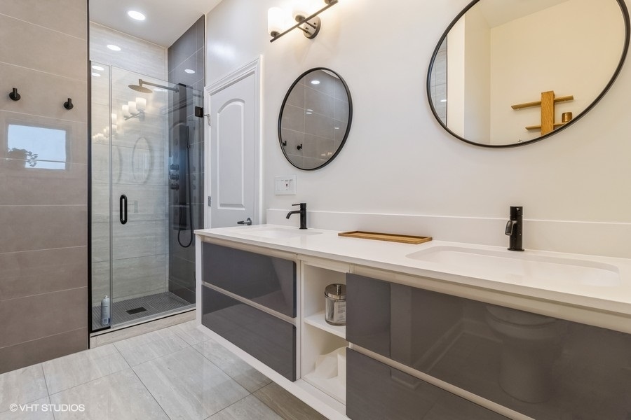 2122 West Rice Street, Unit 4 Chicago, IL 60622 - Photo 11 of 22 a bathroom with a sink mirror and shower