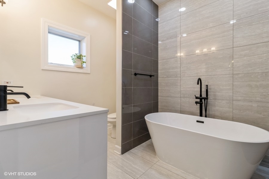 2122 West Rice Street, Unit 4 Chicago, IL 60622 - Photo 12 of 22 a bathroom with a sink a window and a mirror