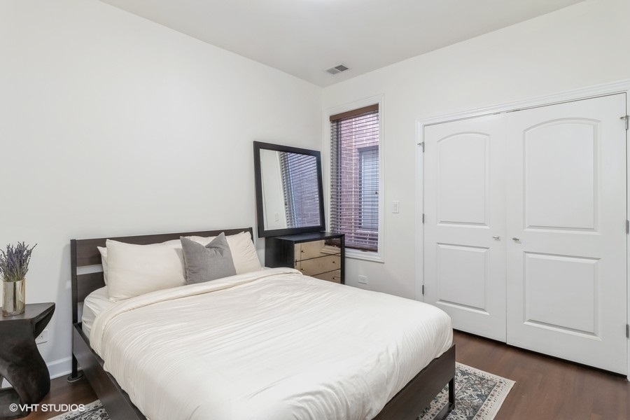 2122 West Rice Street, Unit 4 Chicago, IL 60622 - Photo 14 of 22 a bedroom with a large bed and a closet
