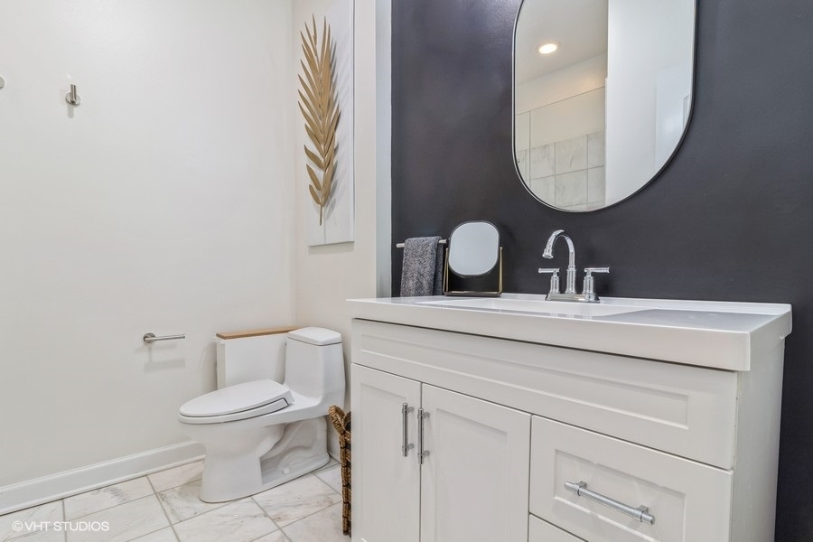 2122 West Rice Street, Unit 4 Chicago, IL 60622 - Photo 16 of 22 a bathroom with a toilet sink and mirror