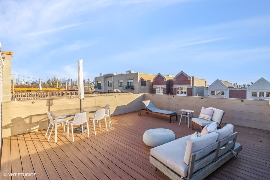 2122 West Rice Street, Unit 4 Chicago, IL 60622 - Photo 17 of 22 a view of a balcony with dining table and chairs