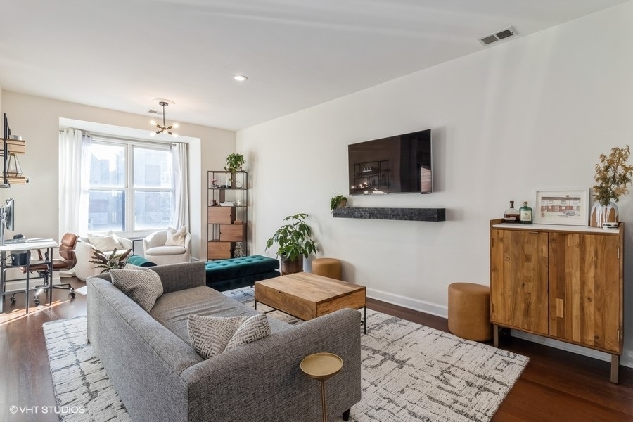 2122 West Rice Street, Unit 4 Chicago, IL 60622 - Photo 6 of 22 a living room with furniture and a flat screen tv