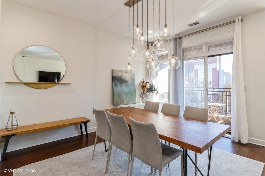 2122 West Rice Street, Unit 4 Chicago, IL 60622 - Photo 7 of 22 a view of a dining room with furniture window and wooden floor