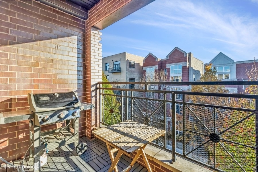 2122 West Rice Street, Unit 4 Chicago, IL 60622 - Photo 8 of 22 a view of balcony with wooden floor and outdoor seating