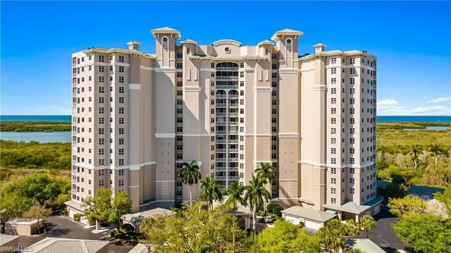 a front view of a residential apartment building with a yard