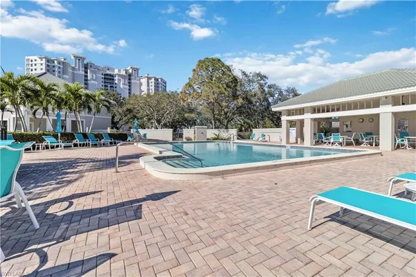 a swimming pool with outdoor seating and yard