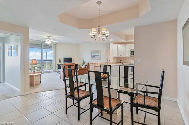 a view of a dining room with furniture and chandelier