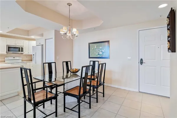 a view of a dining room with furniture and chandelier