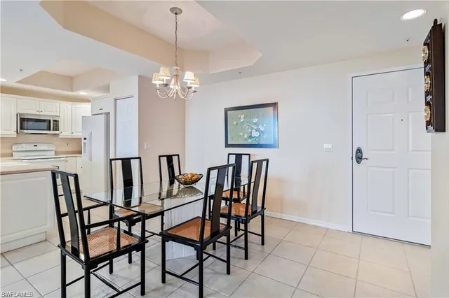 a view of a dining room with furniture and chandelier