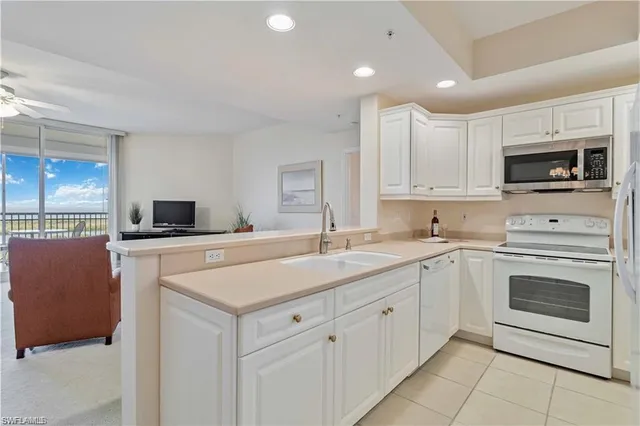 a kitchen with a sink stove and microwave