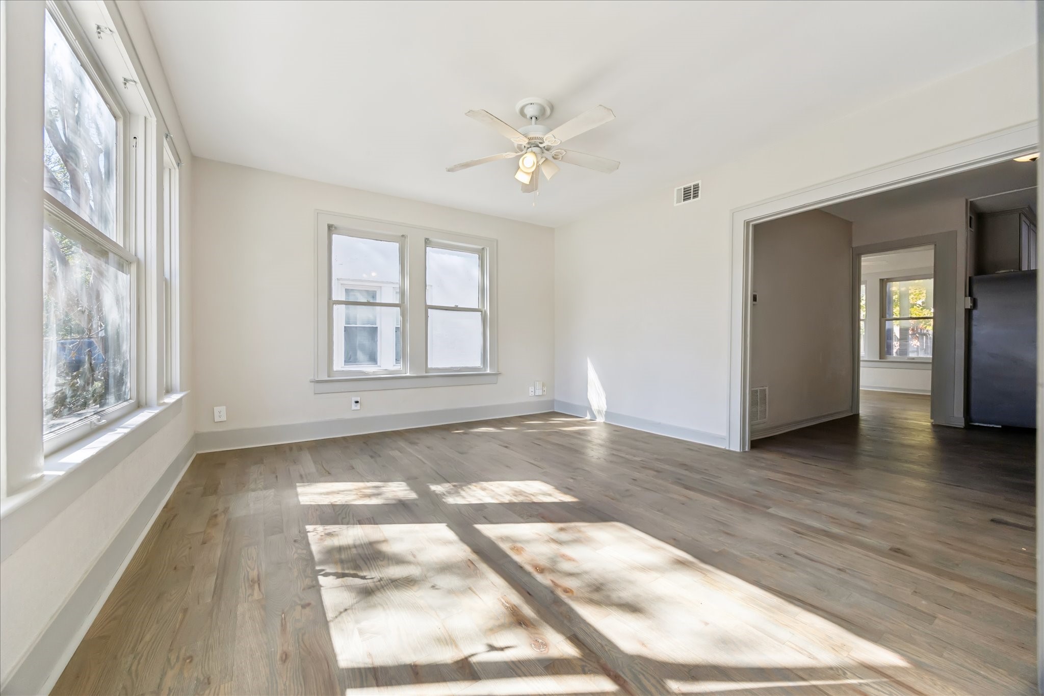 1632 Hawthorne Street, Unit 2 Houston, TX 77006 - Photo 2 of 8 an empty room with wooden floor and windows