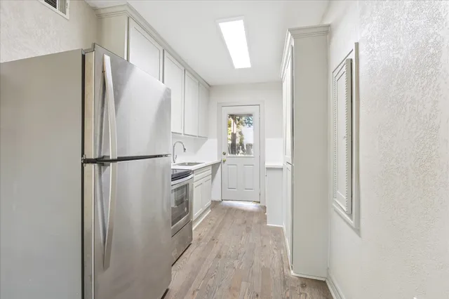 a kitchen with a refrigerator and a refrigerator