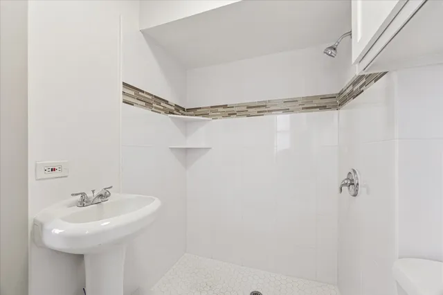 a bathroom with a sink a mirror and a shower