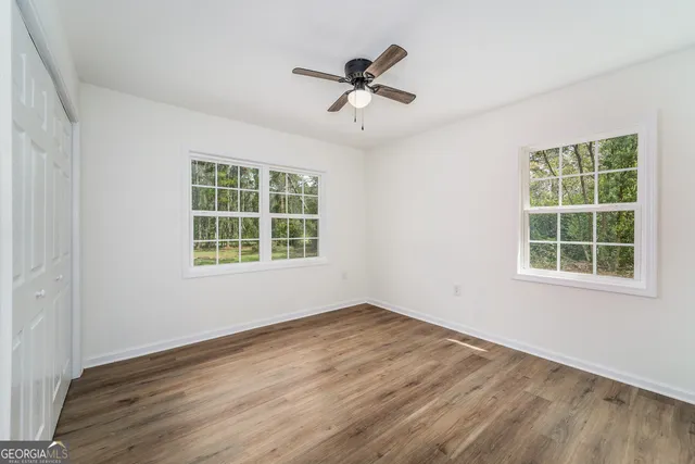 wooden floor in an empty room with a window
