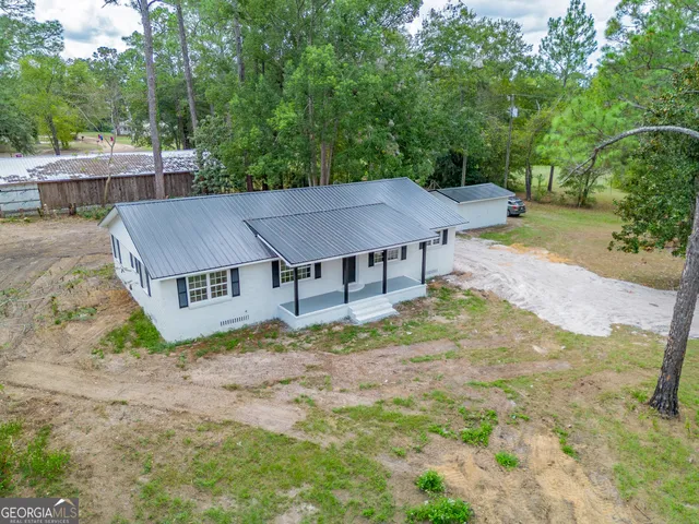 an aerial view of a house with swimming pool