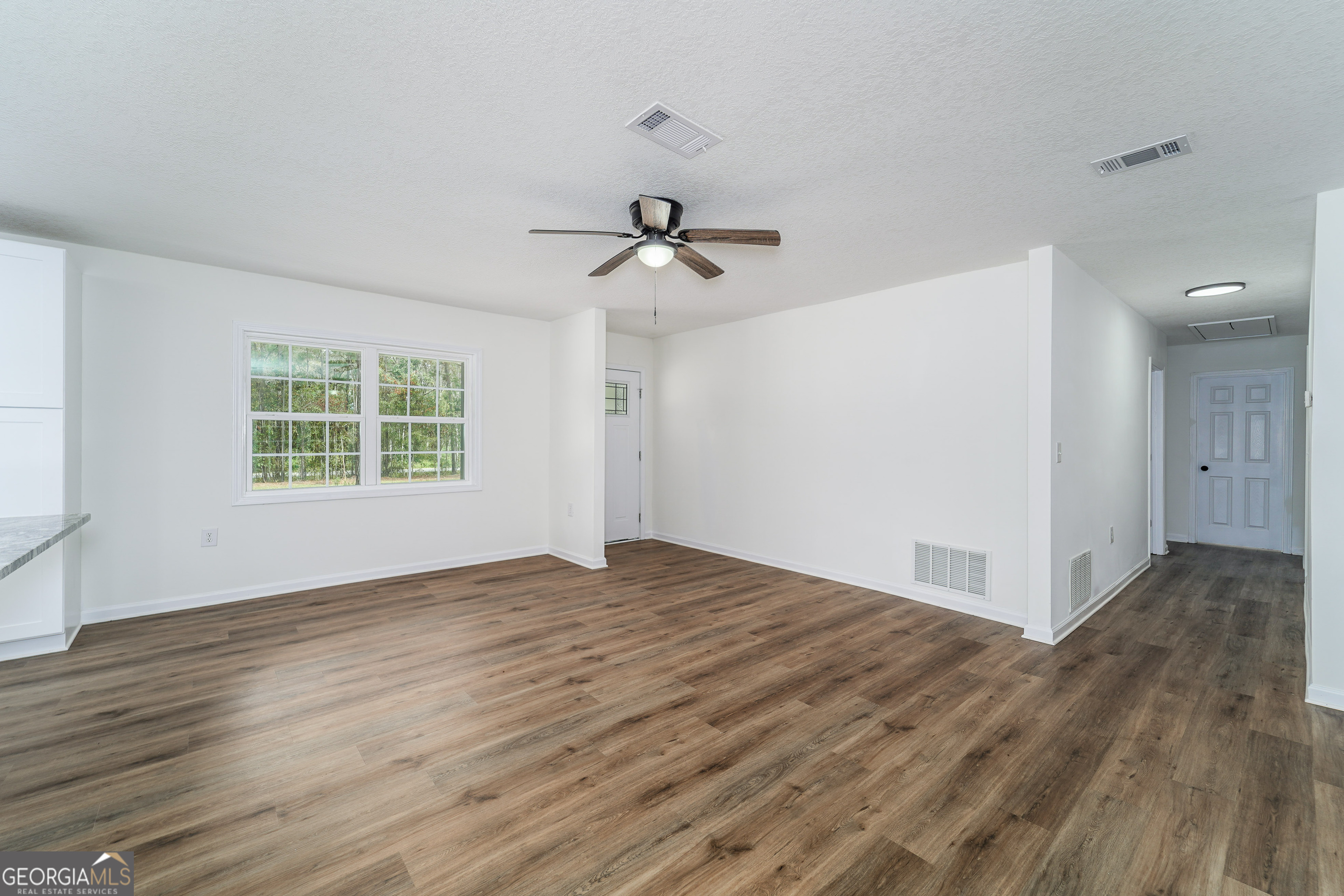 3551 Cason Road Blackshear, GA 31516 - Photo 7 of 24 wooden floor in an empty room with a window