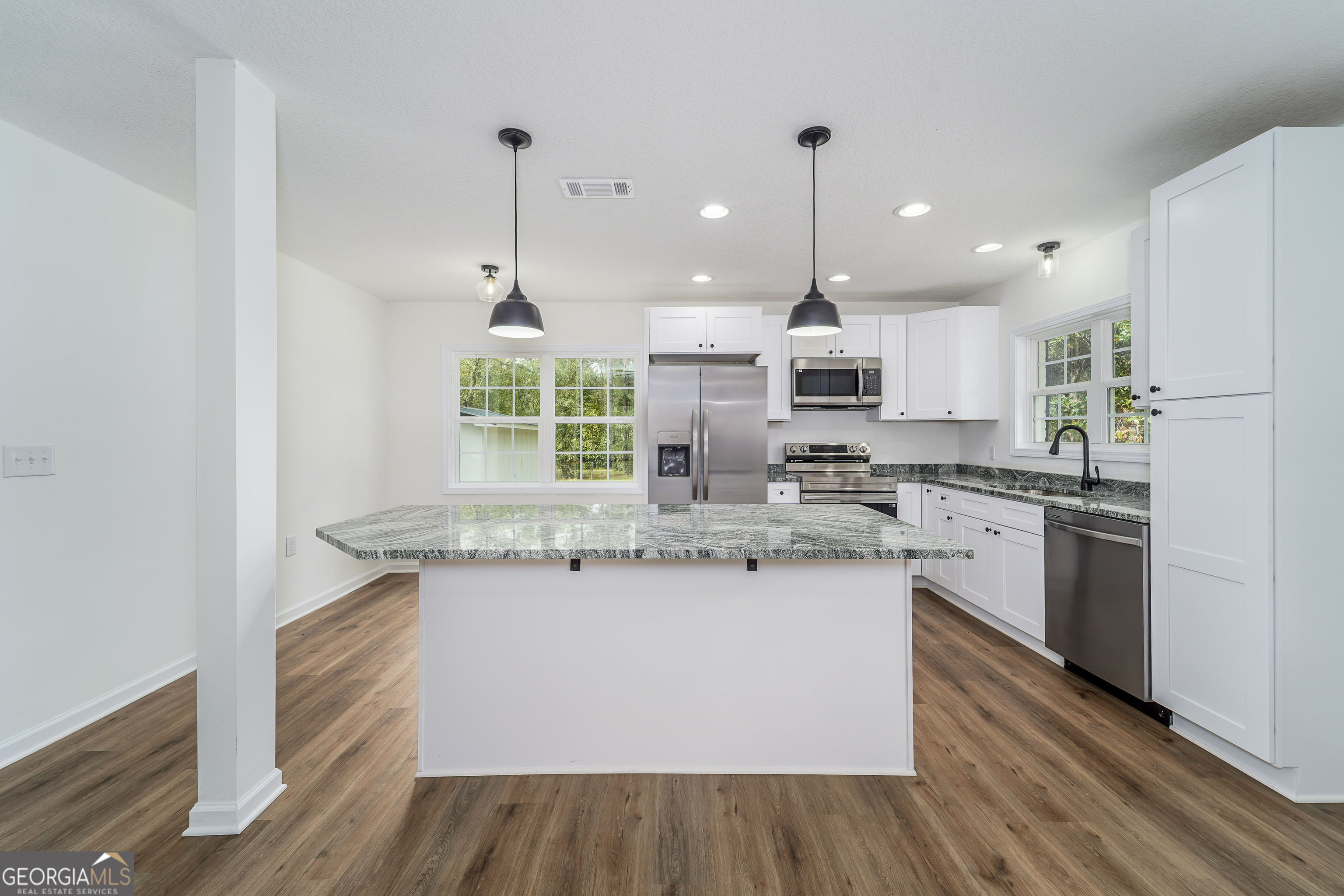 3551 Cason Road Blackshear, GA 31516 - Photo 9 of 24 a kitchen with stainless steel appliances granite countertop a sink a stove and a refrigerator