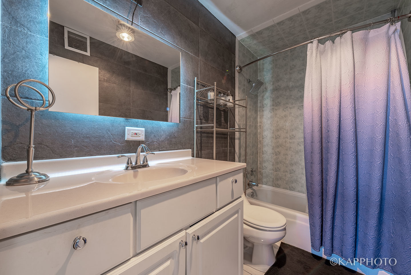 3930 North Pine Grove Avenue, Unit 2005 Chicago, IL 60613 - Photo 11 of 20 a bathroom with a sink a toilet and shower