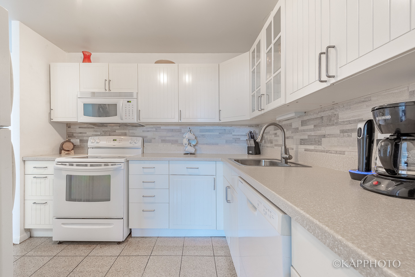 3930 North Pine Grove Avenue, Unit 2005 Chicago, IL 60613 - Photo 13 of 20 a kitchen with cabinets appliances and a sink