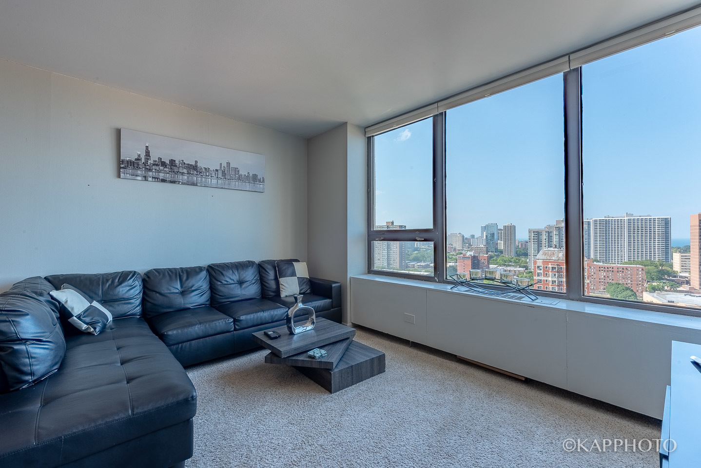 3930 North Pine Grove Avenue, Unit 2005 Chicago, IL 60613 - Photo 4 of 20 a living room with furniture and a large window