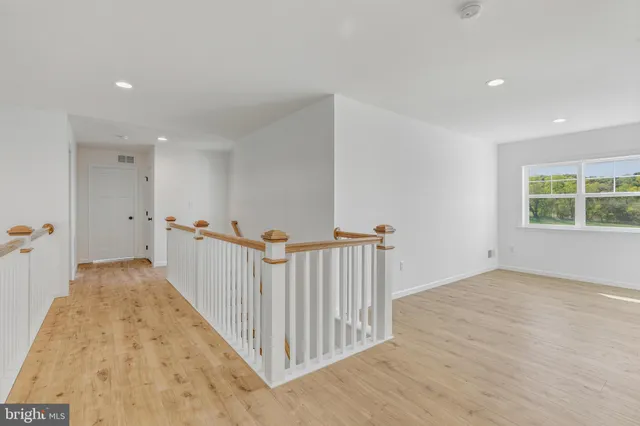 a view of a room with wooden floor and windows