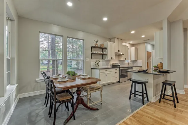 a view of a dining room with furniture and window
