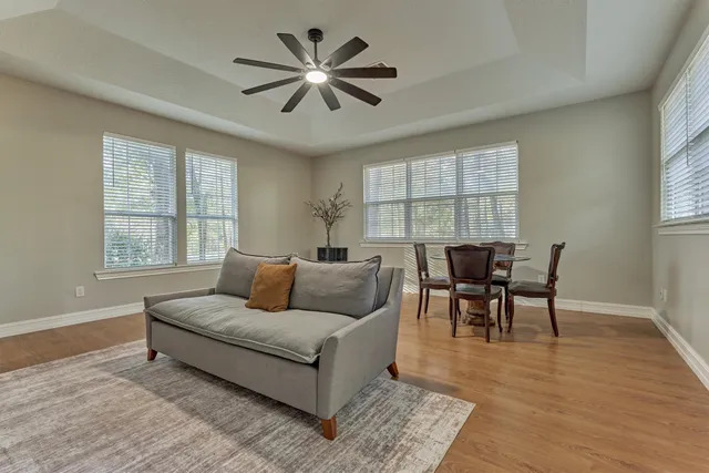a living room with furniture and a wooden floor