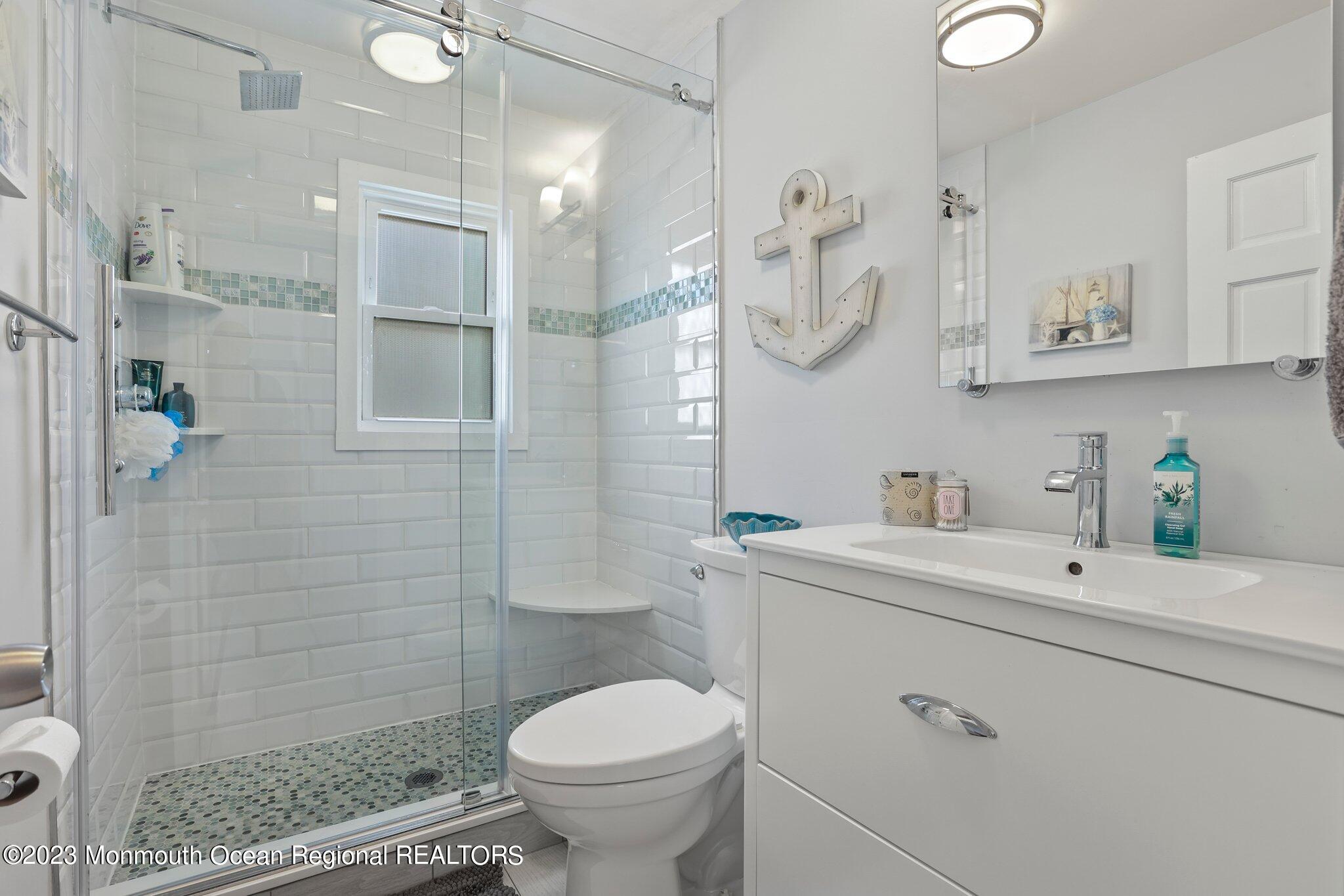 107 17th Avenue Belmar, NJ 07719 - Photo 11 of 32 a bathroom with a sink a toilet and shower