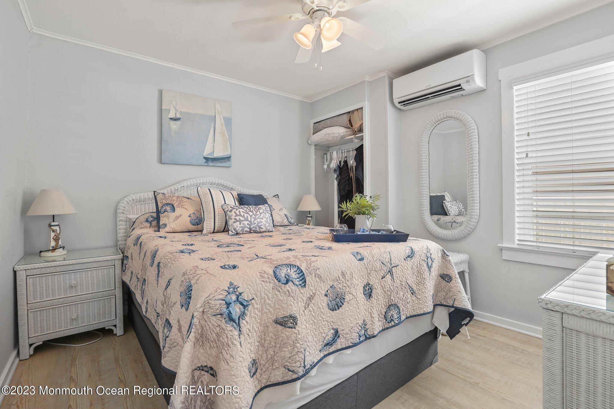 107 17th Avenue Belmar, NJ 07719 - Photo 12 of 32 a bedroom with a bed and a chandelier