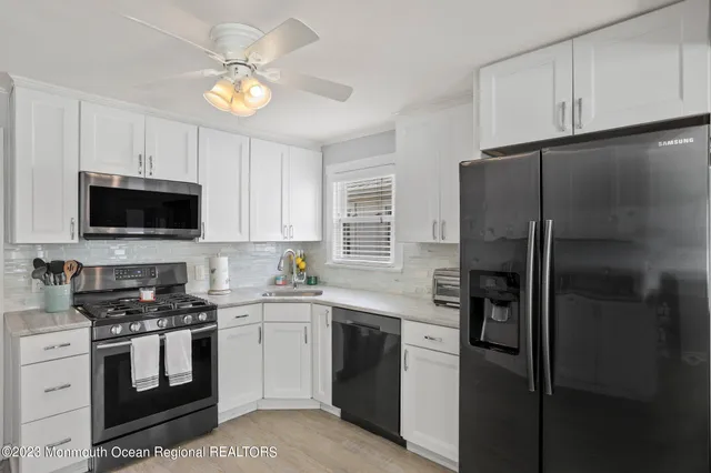 a kitchen with a refrigerator stove and microwave