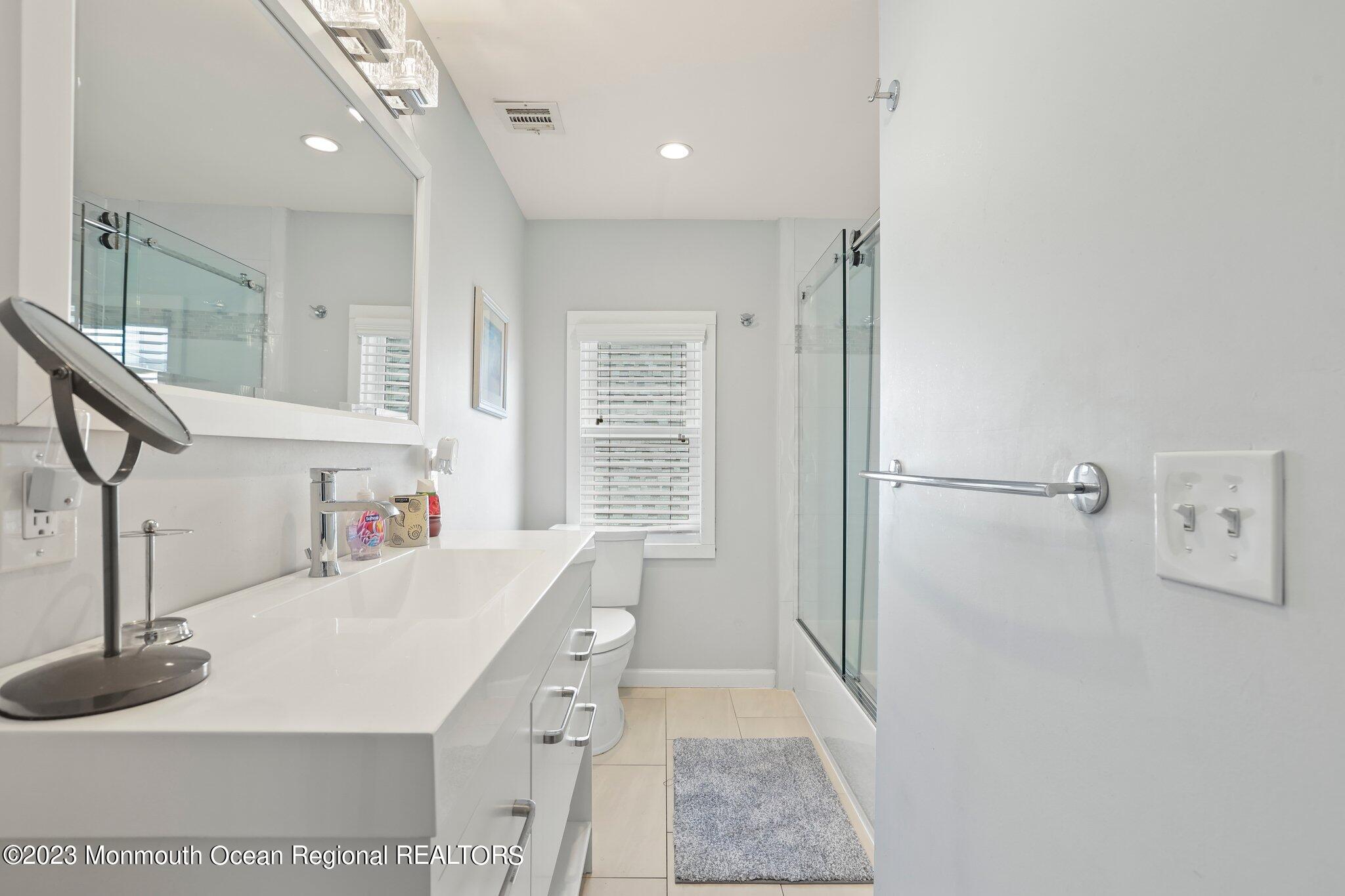 107 17th Avenue Belmar, NJ 07719 - Photo 18 of 32 a kitchen with a sink a refrigerator and a stove