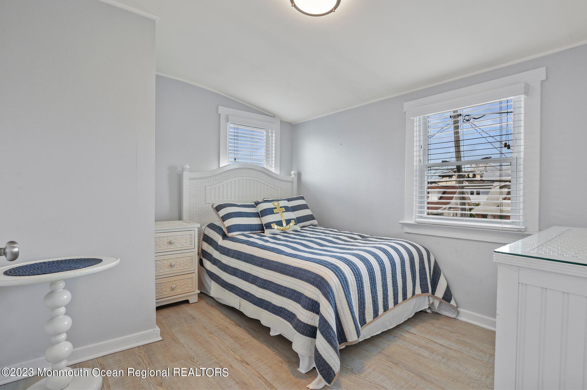107 17th Avenue Belmar, NJ 07719 - Photo 22 of 32 a bedroom with a bed and a window