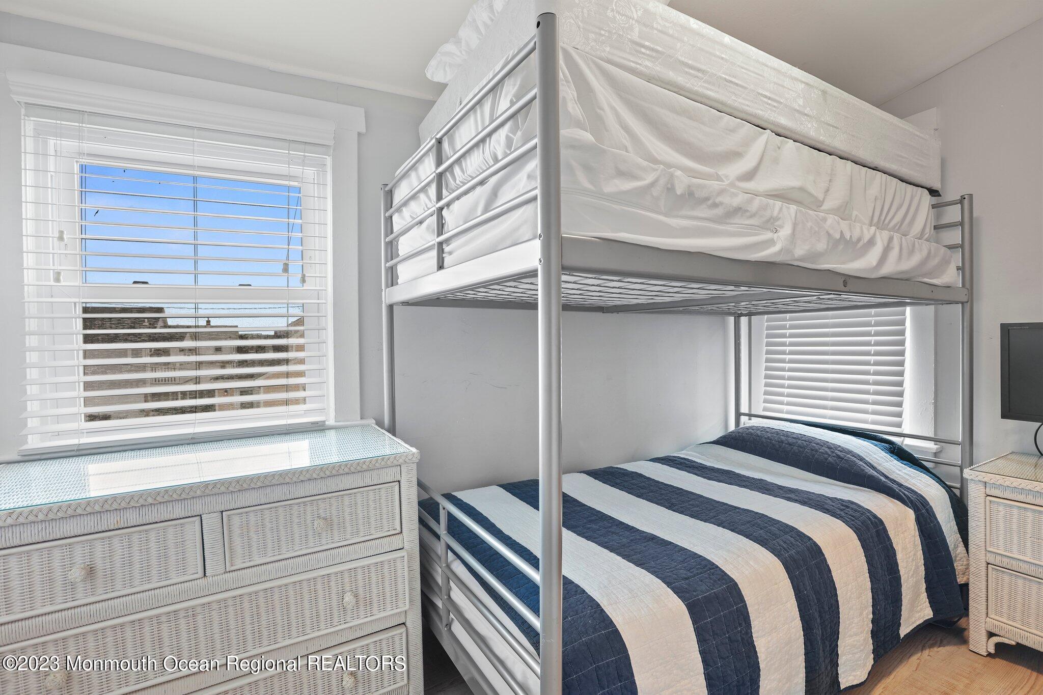 107 17th Avenue Belmar, NJ 07719 - Photo 23 of 32 a bedroom with a bed and a window