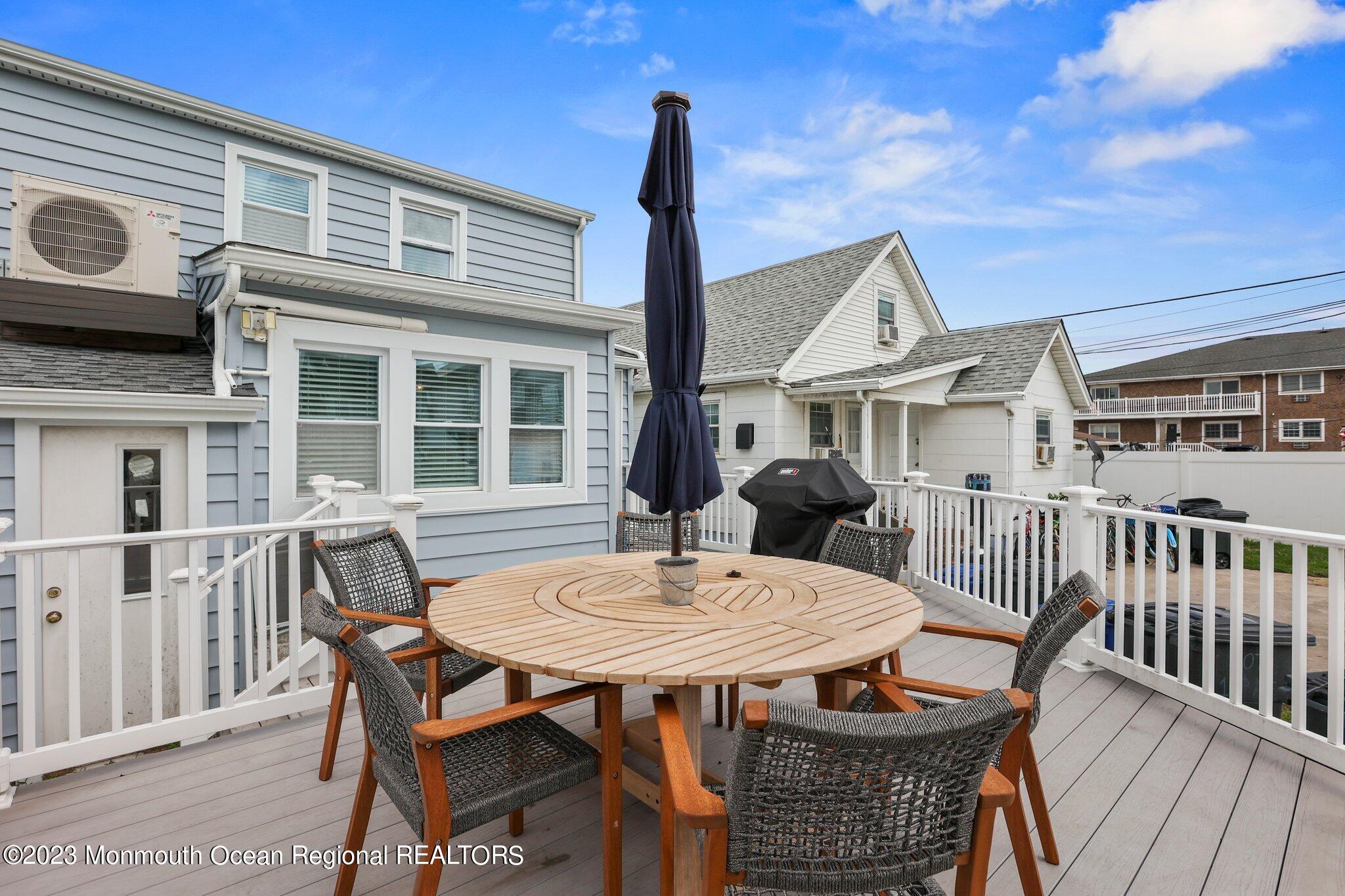 107 17th Avenue Belmar, NJ 07719 - Photo 25 of 32 a table and chairs in front of a house