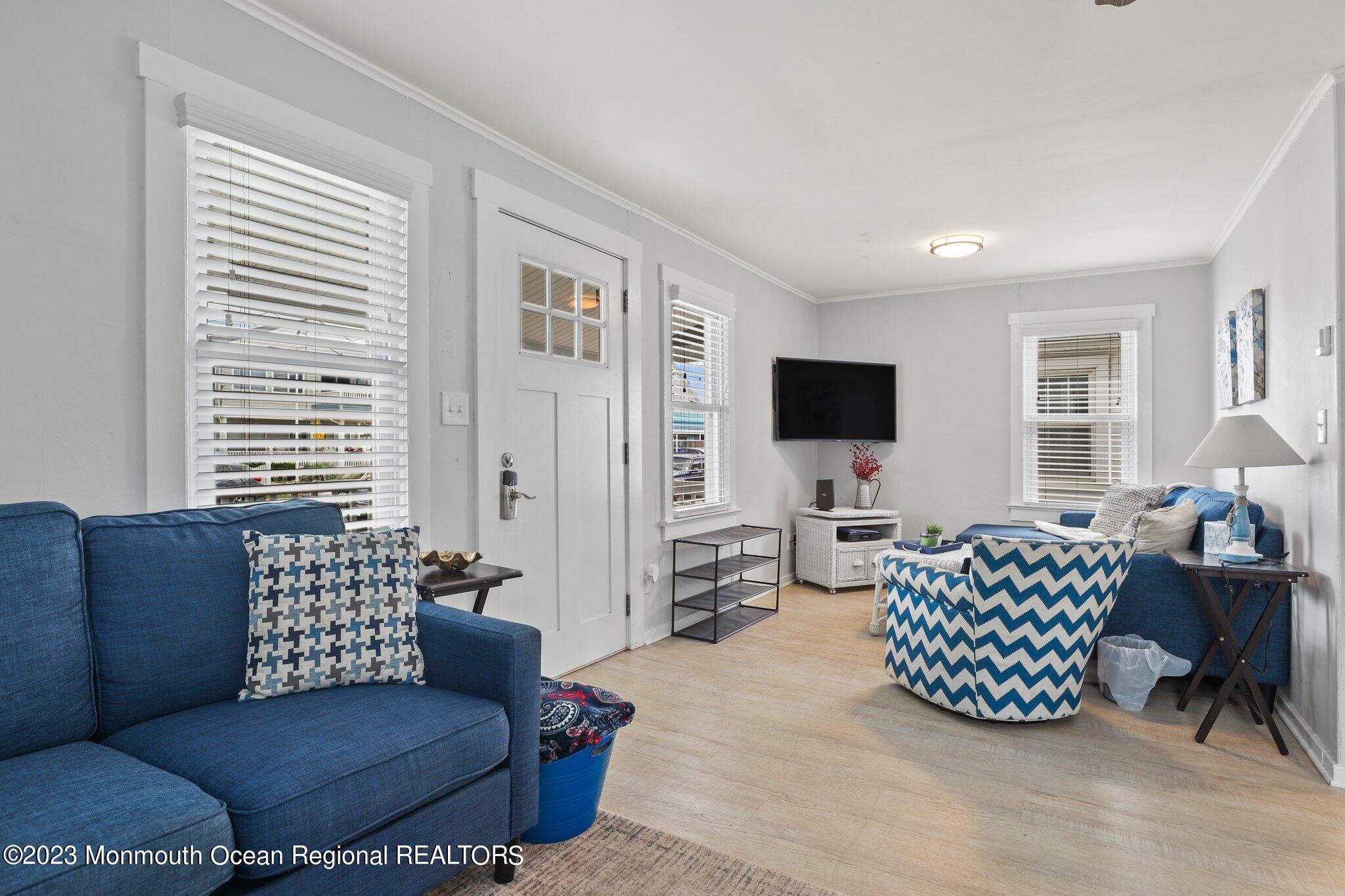 107 17th Avenue Belmar, NJ 07719 - Photo 7 of 32 a living room with furniture and a flat screen tv