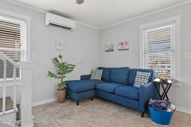 a living room with furniture and a potted plant