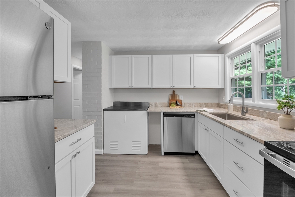 33 Ruthellen Road Framingham, MA 01701 - Photo 12 of 42 a kitchen with white cabinets and white appliances