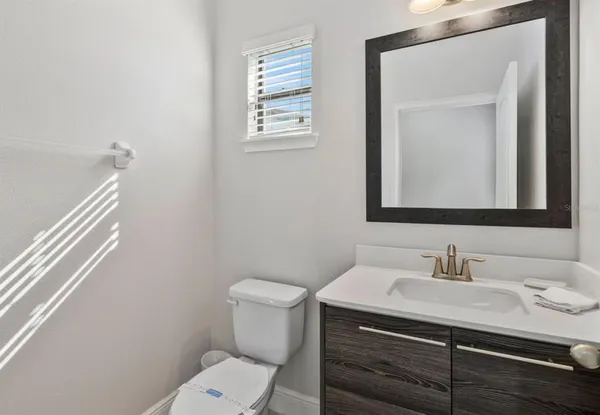 a bathroom with a sink toilet and mirror