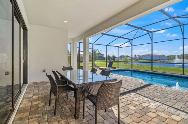 a view of a dining room with furniture and a floor to ceiling window