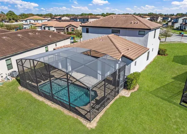 an aerial view of a house with swimming pool