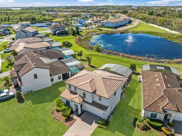 an aerial view of a house with a swimming pool yard and outdoor seating