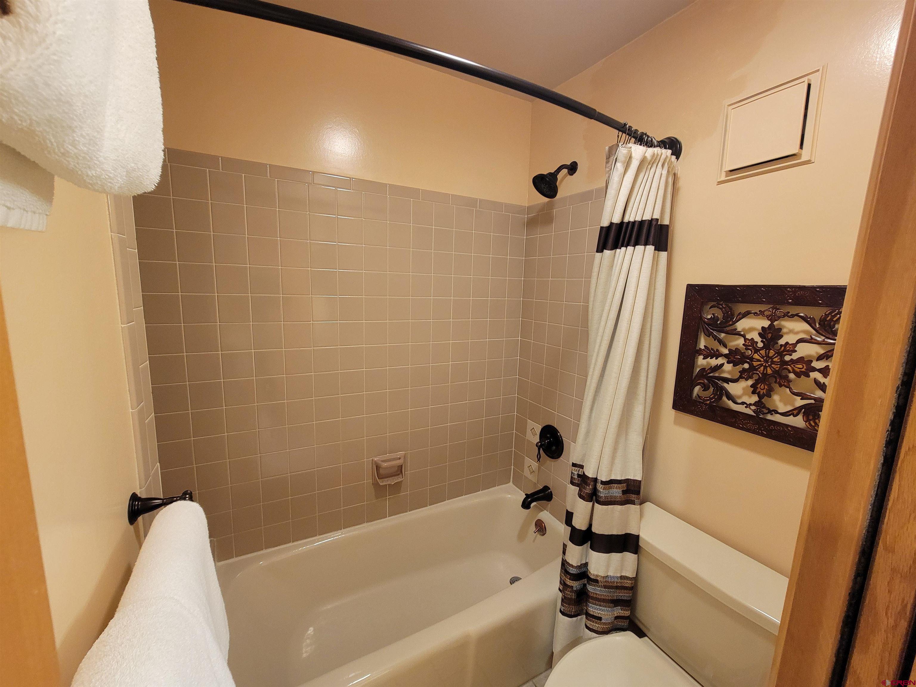 71 Needles Way, Unit 347 Durango, CO 81301 - Photo 12 of 31 a bathroom with a bathtub and a shower