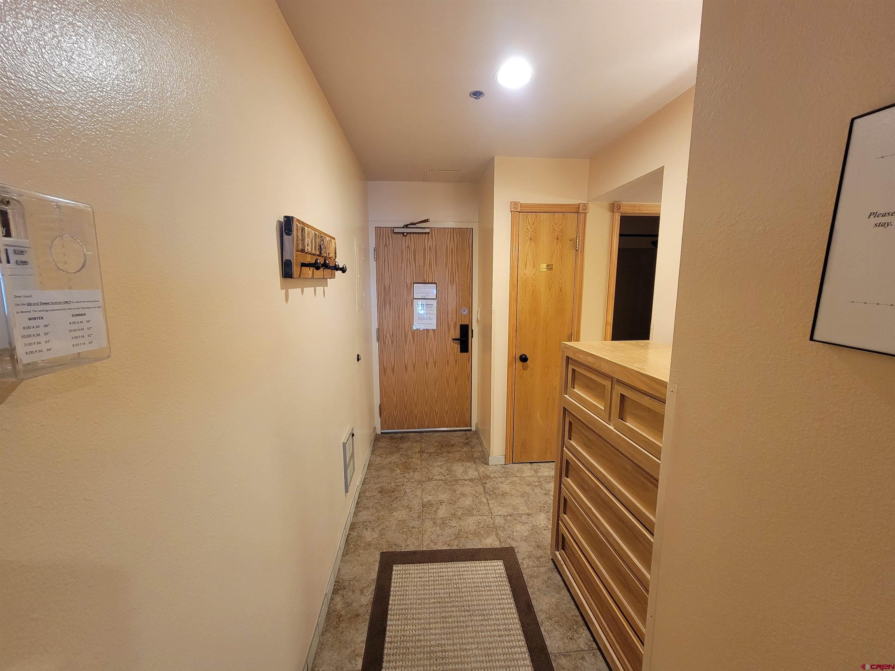 71 Needles Way, Unit 347 Durango, CO 81301 - Photo 14 of 31 a view of a hallway with wooden floor and a bathroom