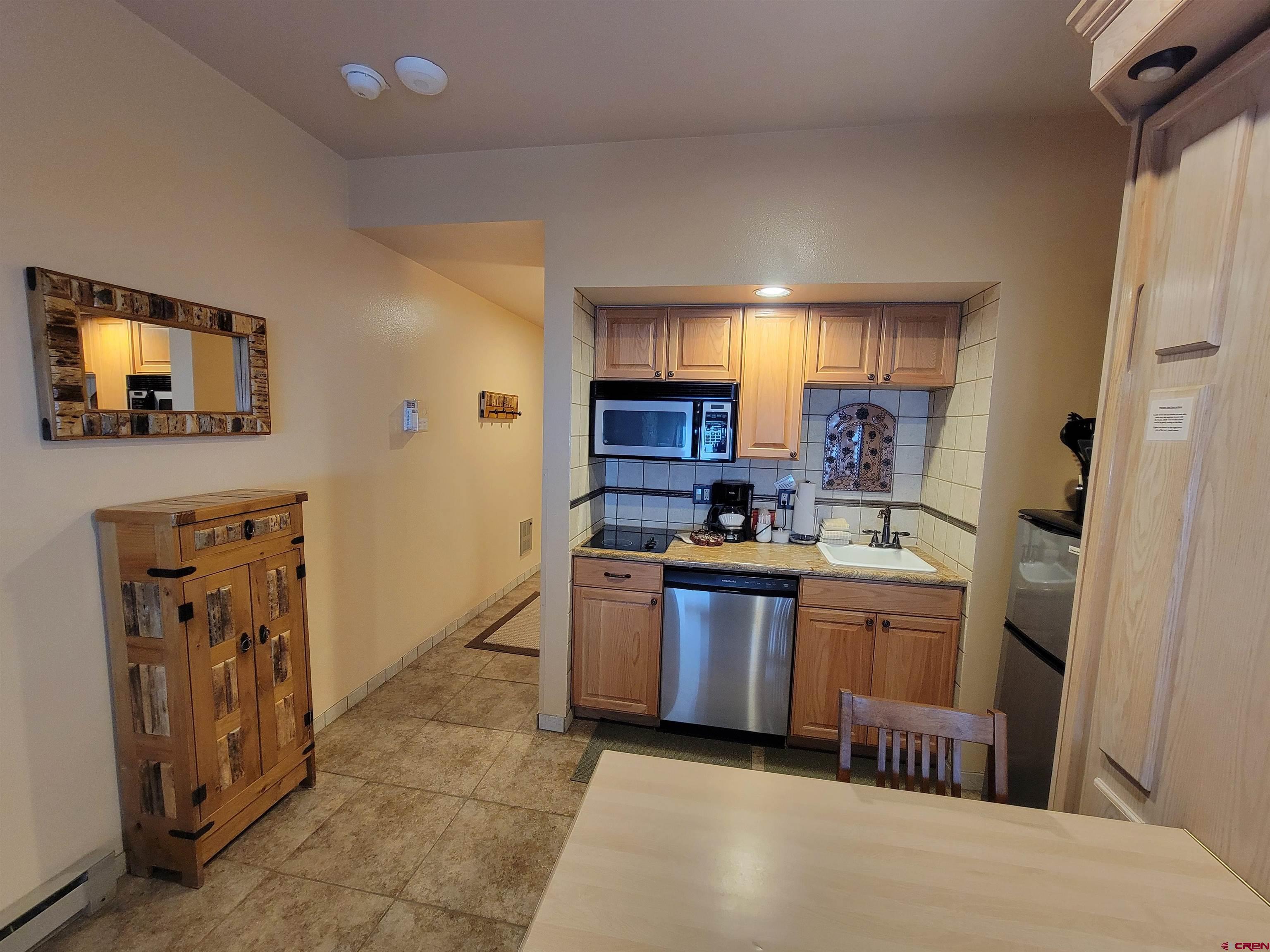 71 Needles Way, Unit 347 Durango, CO 81301 - Photo 15 of 31 a kitchen with stainless steel appliances granite countertop a refrigerator and a stove top oven