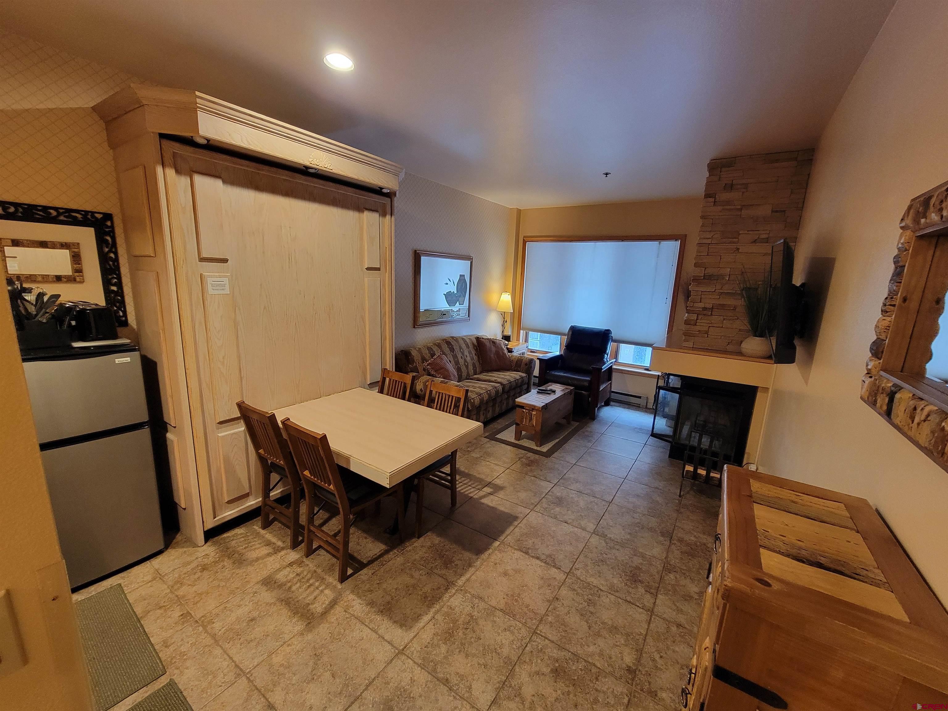 71 Needles Way, Unit 347 Durango, CO 81301 - Photo 18 of 31 a living room with furniture a flat screen tv and a refrigerator