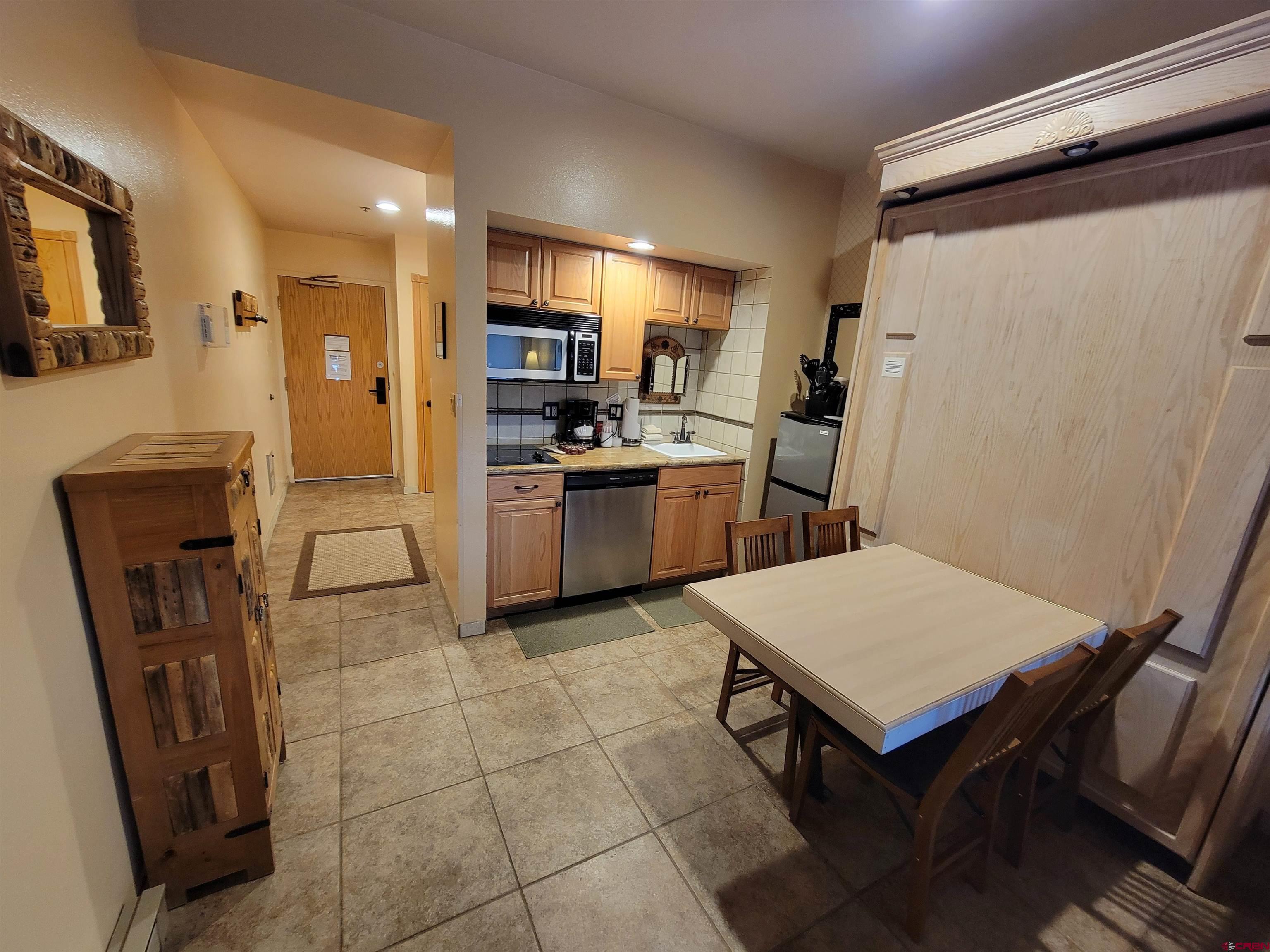 71 Needles Way, Unit 347 Durango, CO 81301 - Photo 20 of 31 a kitchen with refrigerator cabinets and wooden floor